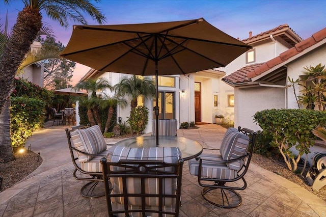 patio terrace at dusk featuring outdoor dining space