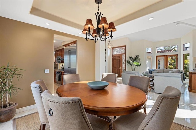 dining room featuring recessed lighting, a notable chandelier, baseboards, french doors, and a tray ceiling