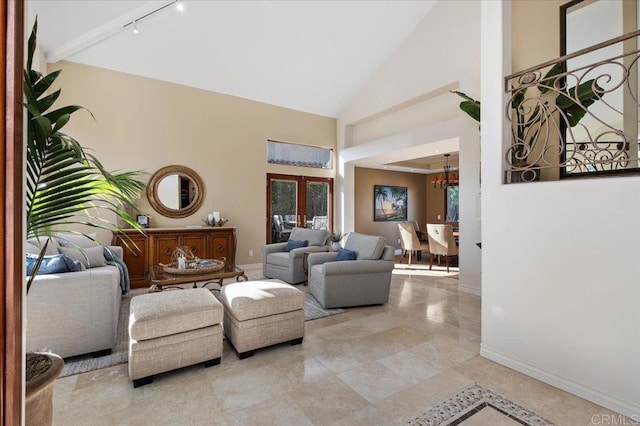 living room with baseboards, high vaulted ceiling, a notable chandelier, and french doors