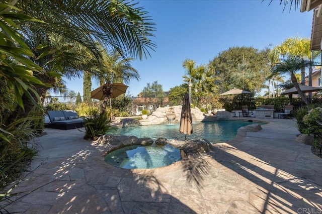 view of pool with a fenced in pool, a patio area, fence, and an in ground hot tub