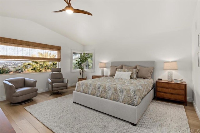 bedroom with ceiling fan, baseboards, vaulted ceiling, and wood finished floors