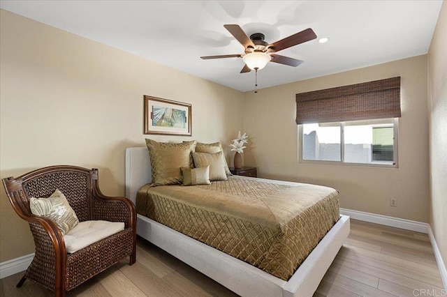 bedroom featuring a ceiling fan, recessed lighting, light wood-style flooring, and baseboards