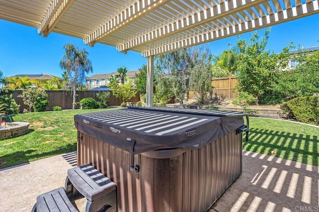 view of patio featuring a hot tub, a pergola, and a fenced backyard