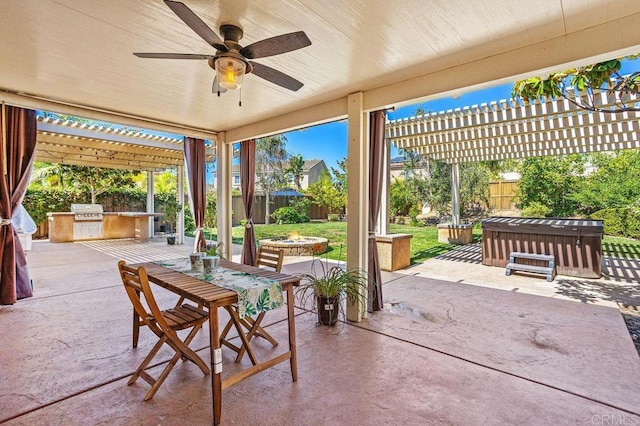 view of patio / terrace with a fenced backyard, a fire pit, an outdoor kitchen, and a pergola