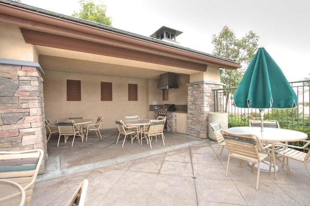 view of patio featuring an outdoor kitchen, a grill, and outdoor dining area