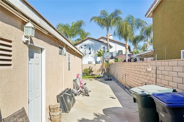 view of property exterior with a patio area, a fenced backyard, and stucco siding