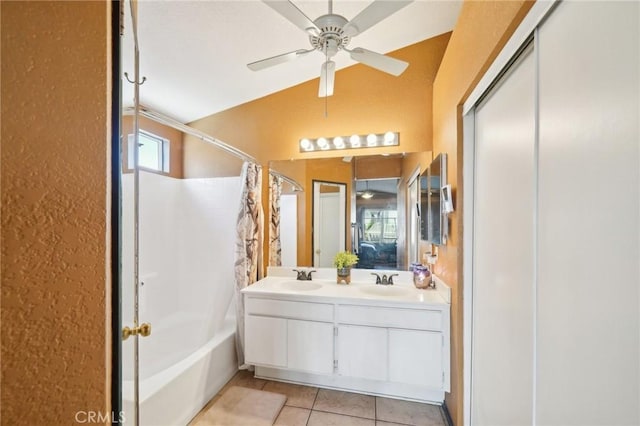 bathroom featuring double vanity, a ceiling fan, tile patterned floors, shower / bath combo with shower curtain, and a sink