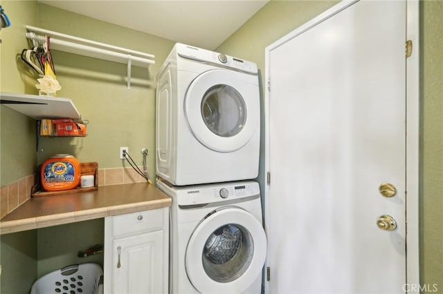 laundry room featuring laundry area and stacked washer and dryer