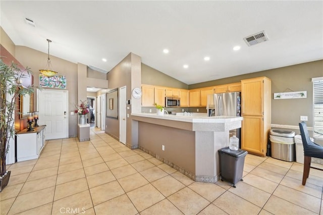 kitchen with appliances with stainless steel finishes, light countertops, visible vents, and light brown cabinets