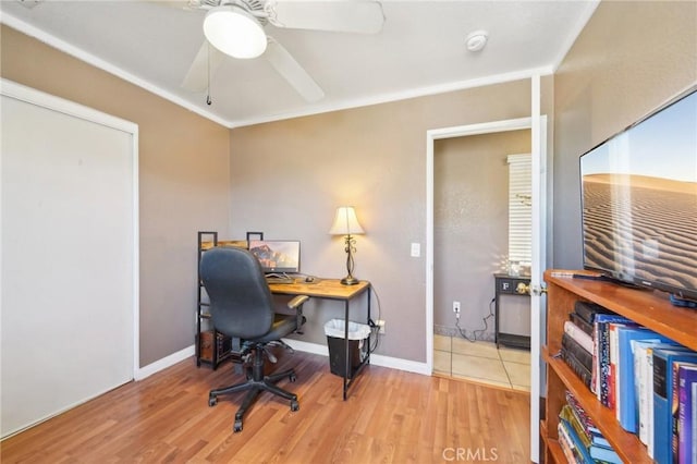 office space with light wood finished floors, a ceiling fan, and baseboards