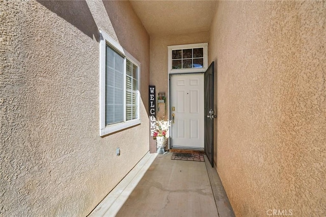 property entrance with stucco siding