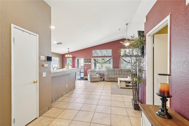 living room with lofted ceiling and light tile patterned floors