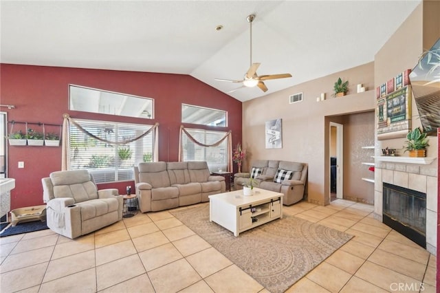 living room with lofted ceiling, ceiling fan, light tile patterned floors, a fireplace, and visible vents