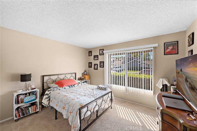 carpeted bedroom with a textured ceiling and baseboards