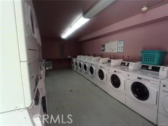 community laundry room with separate washer and dryer and stacked washer / drying machine