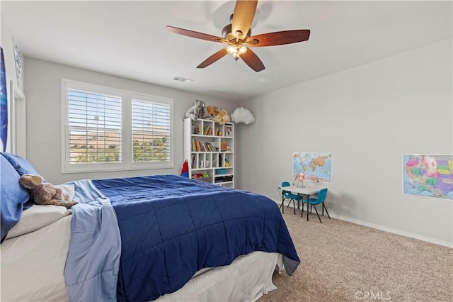 carpeted bedroom featuring visible vents, a ceiling fan, and baseboards