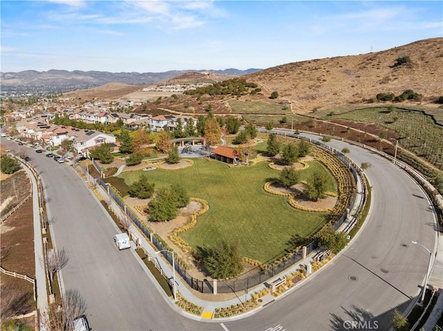 drone / aerial view featuring a residential view and a mountain view