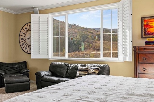 carpeted bedroom with a mountain view and crown molding