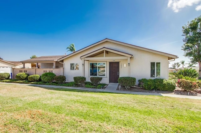 view of front of home with a front lawn and stucco siding