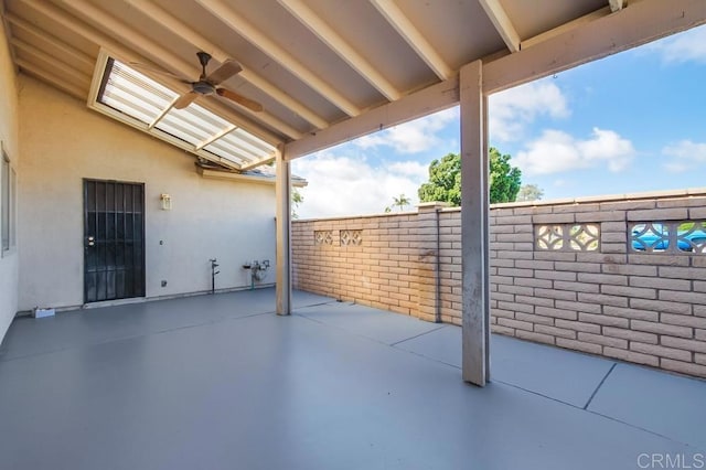 view of patio with fence private yard and a ceiling fan