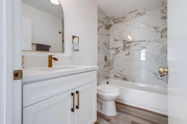 bathroom featuring toilet, bathing tub / shower combination, vanity, and wood finished floors