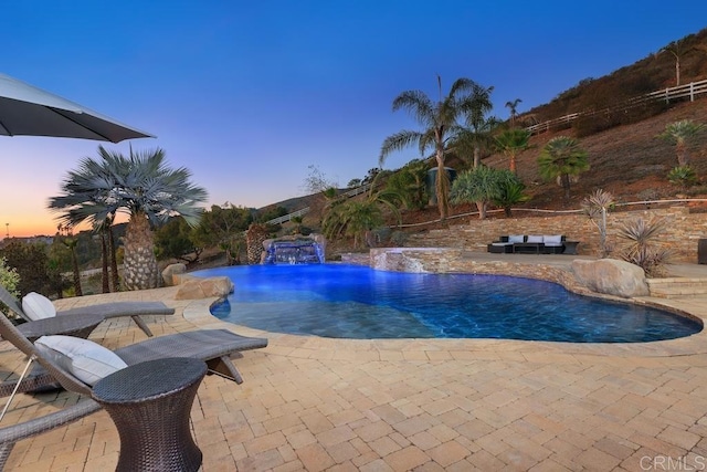 outdoor pool with a patio and fence