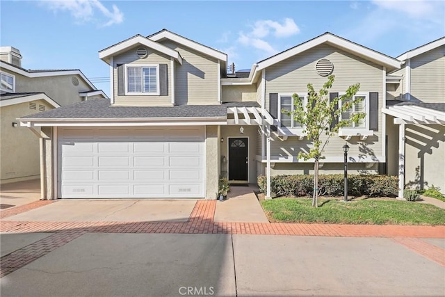 view of front of home featuring a shingled roof, driveway, and an attached garage