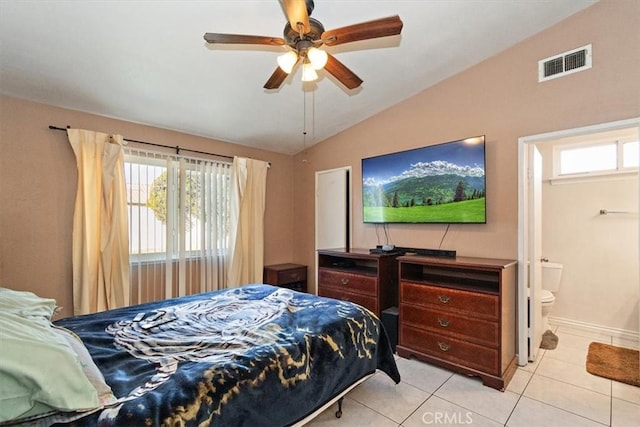 bedroom featuring light tile patterned floors, ensuite bathroom, a ceiling fan, visible vents, and vaulted ceiling