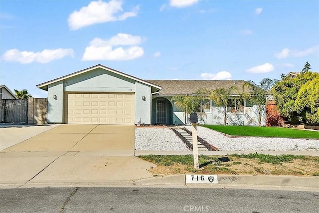 single story home featuring an attached garage and concrete driveway