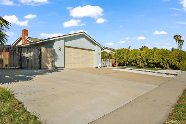 view of front of property featuring a garage, driveway, and stucco siding