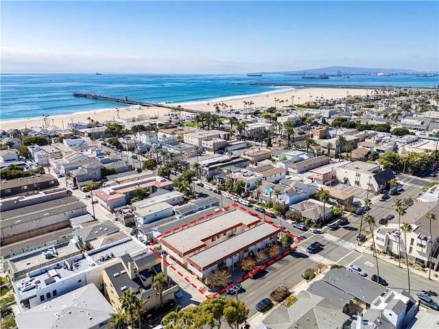 birds eye view of property featuring a water view, a residential view, and a beach view