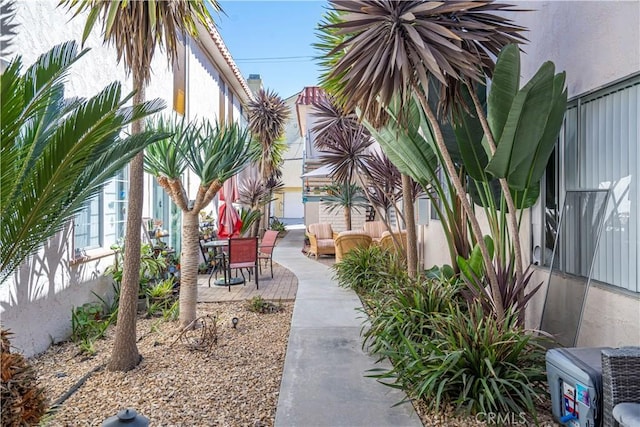 view of property's community with outdoor lounge area and a patio