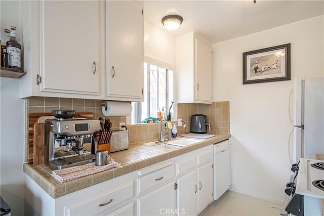 1102 Central Ave, Seal Beach, CA 90740 - kitchen with tile counters, a sink, white appliances, tasteful backsplash, and white cabinetry