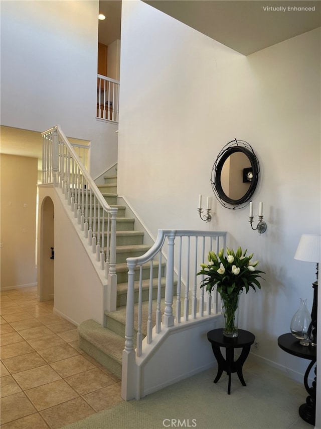 staircase with tile patterned flooring and baseboards