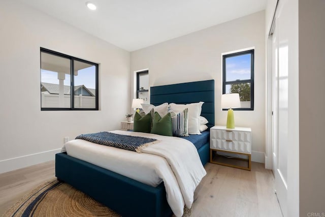 bedroom featuring light wood-type flooring, baseboards, and recessed lighting