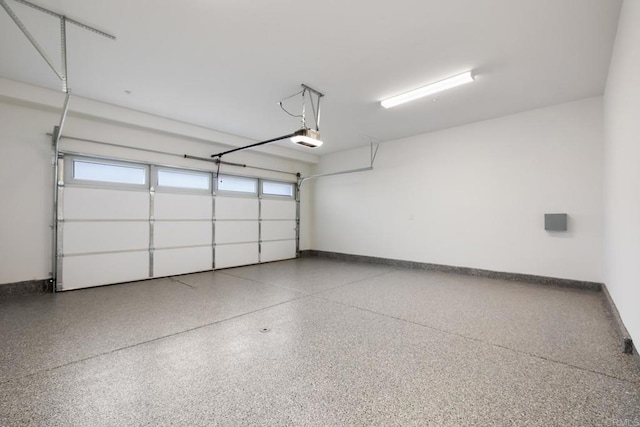 garage featuring baseboards and a garage door opener