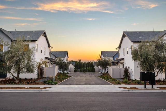 view of road with sidewalks, a residential view, and curbs