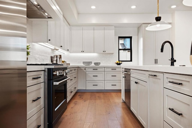 kitchen featuring hanging light fixtures and white cabinets