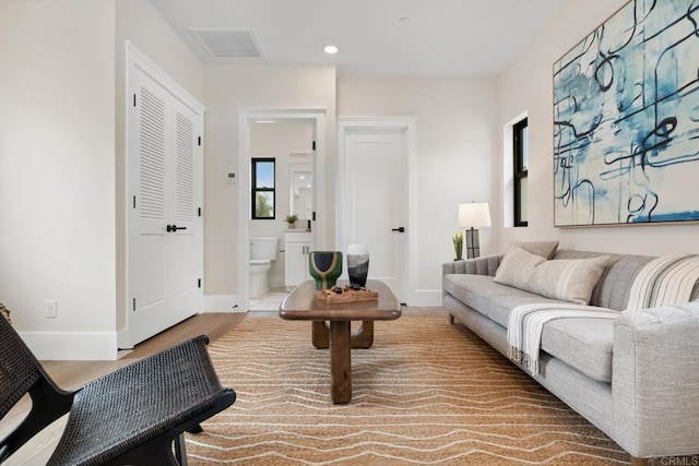 sitting room with recessed lighting, visible vents, baseboards, and wood finished floors