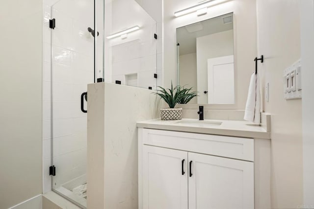 full bathroom with a shower stall, visible vents, and vanity