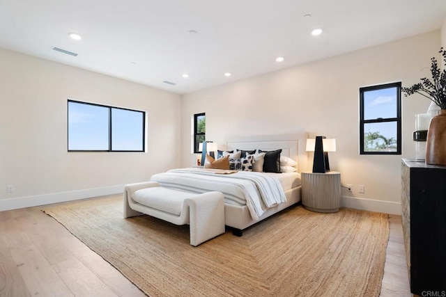 bedroom with light wood-type flooring, baseboards, visible vents, and recessed lighting