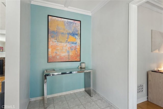 interior space with a fireplace, baseboards, crown molding, and tile patterned floors