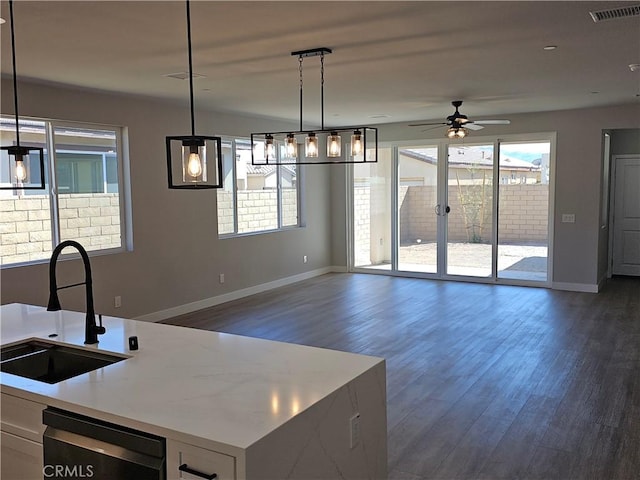 kitchen with visible vents, plenty of natural light, open floor plan, and a sink