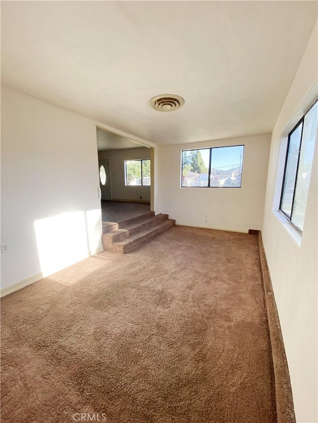 carpeted spare room with visible vents