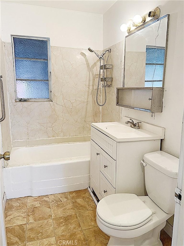 full bathroom featuring toilet, shower / tub combination, stone finish floor, and vanity