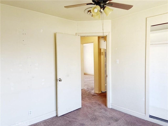 unfurnished bedroom featuring light carpet, a closet, a ceiling fan, and baseboards