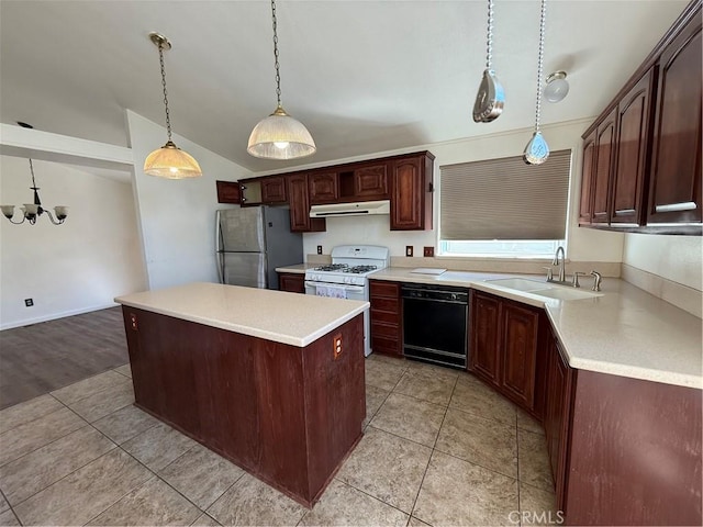 kitchen featuring black dishwasher, light countertops, freestanding refrigerator, a kitchen island, and a sink