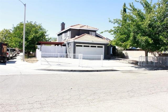 mediterranean / spanish-style house featuring a garage, driveway, fence, and a tiled roof