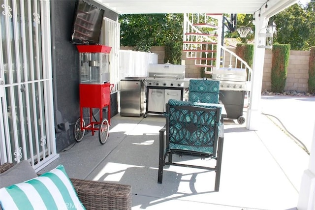 view of patio / terrace featuring grilling area and fence