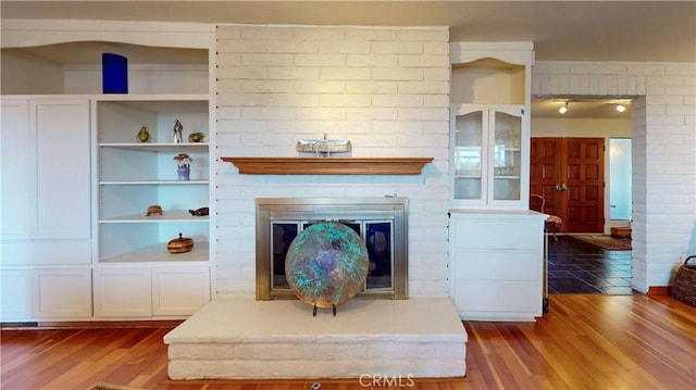 living room with dark wood-style floors and a fireplace